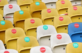 KYIV, UKRAINE - AUGUST 5, 2020: Seats with Covid-19 quarantine labels seen on the tribunes of NSC Olimpiyskyi stadium in Kyiv during the UEFA Europa League game Shakhtar Donetsk v VfL Wolfsburg