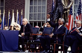 F.W. de Klerk, left, the last president of apartheid-era South Africa, and Nelson Mandela, his successor, wait to speak in Philadelphia, Pennsylvania