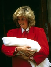 Princess Diana, Princess of Wales, smiles as she carries her newborn baby, Prince Harry, when she leaves St. Mary's Hospital in London in September 1984.