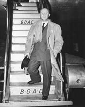Christian Dior, well known French fashion designer and credited as the originator of the "New Look" in 1947, arrives from London and Paris on a BOAC Speedbird.