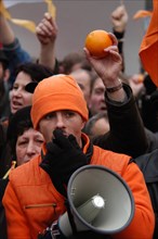 Orange revolution in Ukraine. Young man dressed orange speaks using a loudspeaker during the demonstration of Ukrainian migrants in the Czech Republic to support Ukrainian oppositional presidential ca...