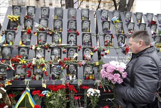 Kiev, Ukraine. 20th Feb, 2020. A man lays flowers to memorial in memory of the Heavenly Hundred, activists who were killed during anti-government protests of 2014, in Kiev, Ukraine, on 20 February 202...