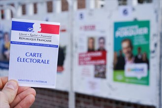 AMIENS, FRANCE - MARCH 15, 2020 : electoral posters for french local elections and voter card.
