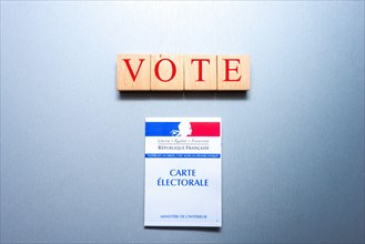 French voting card or carte electorale with wooden blocks and the word vote on them