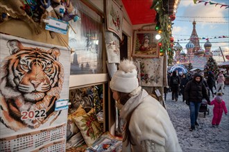 Moscow, Russia. 25th of December, 2021 People buy Christmas souvenirs at the Res Square during annual festival "Journey to Christmas" in the center of Moscow, Russia. The 2022 year will be the Tiger i...