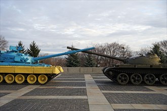 Russia Ukraine war, yellow and blue tank against russian green tank, Russo-Ukrainian crisis concept, Kyiv, Ukraine