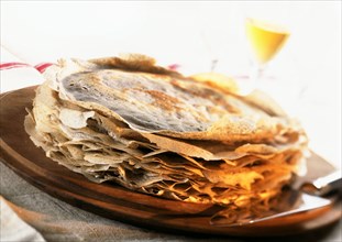 Pile of crepes on plate, close-up