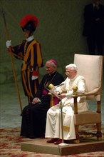 (dpa) - Pope Benedict XVI sits in his chair as he welcomes pilgrims in the audience chamber at the Vatican in Rome, Italy, Monday, 25 April 2005. The Pope welcomed several thousand German pilgrims to ...