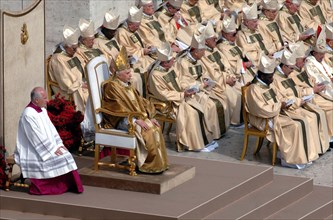 (dpa) - Pope Benedict XVI (2nd from L, front), dressed in the papal robe with tiara, sits on a chair next to the cardinals during the church service on St Peter's Square at the Vatican in Rome, Italy,...