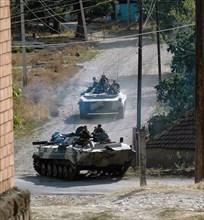 Infantry and armored personnel carriers of Russia's 17th Motor Rifle Division move through the Georgian village Igoeti, 16 August 2008. Russian President Dmitry Medvedev on Saturday signed a ceasefire...