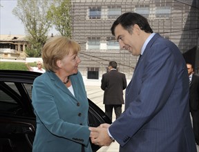 Georgian President Michail Saakashvili (R) shakes hands with German Chancellor Angela Merkel in Tbilisi, Georgia, 17 August 2008. Merkel has taken on one of her most delicate diplomatic challenges to ...