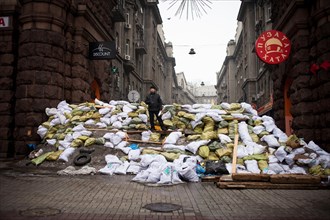 Kiev, Ukraine. 12th Feb, 2014. An anti protester stands on a barricade in maidan square on February 12, 2014. Russia will release the next installment of its $15-billion loan to Ukraine at the end of ...