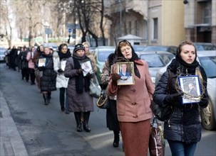 Kiev, Ukraine. 26th February 2014. Families of victims of the recent violence in Kiev, march through the Euromaidan camp for a ceremony honouring the victims. Credit:  Jay Shaw-Baker/Alamy Live News