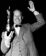 Actor Maurice Chevalier shows off award