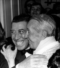 Actors Maurice Chevalier and Fernandel hugging