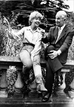 Actors Maurice Chevalier and Leslie Caron share a laugh