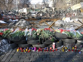 In Kiev city center, flowers among barricades of tires pay tribute to victims of revolution, a few days after fall of Yanukovych