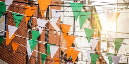 Garland with irish flag colors in a street of Dublin, Ireland - Saint Patrick day celebration concept