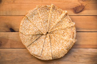 Top view of crepes (french pancakes) folded in circle, on rustic wood background