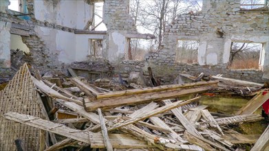 Lots of wooden rubbles on the floor of the house that was damaged during the war in ukraine