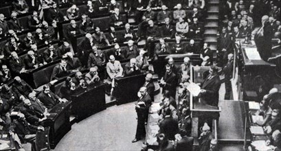 Black and white photo of French politician Edouard Herriot (1872-1957) speaking to the House of Parliament on the subject of debts to Americans.