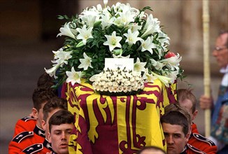 The coffin of Diana, Princess of Wales leaves Westminster Abbey after the funeral service on September 6, 1997. The touching floral tribute from her sons says simpky 'Mummy'.