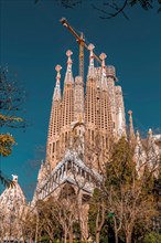 Barcelona, Spain - February 9, 2022: Exterior view of La Sagrada Familia, a large unfinished minor basilica in the Eixample district of Barcelona, Cat