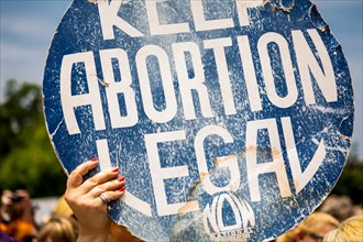 A women holds up a Keep Abortion Legal sign. Outside the capital building in Austin, Texas
