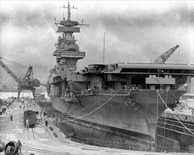 The U.S. Navy aircraft carrier USS Yorktown (CV-5) in Dry Dock No. 1 at the Pearl Harbor Naval Shipyard, 29 May 1942, receiving urgent repairs for damage received in the Battle of Coral Sea. She left ...