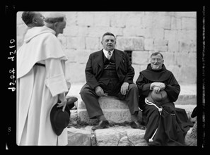 Monsieur & Madame Edouar [i.e., Edouard] Herriot visit to Jerusalem, May 11, 1938. Mr. Herriot & party in front of Ch. [i.e., Church] of Holy Sepulchre showing entrance, Mr. H. seated talking to Fr. E...