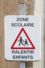 School zone slow down children road sign in French language