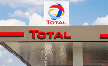 Total sign identifying a gas station. Total is a French multinational oil company and one of the Supermajor oil companies in the world.