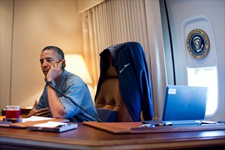 President Barack Obama talks on the phone with NASA's Curiosity Mars rover team aboard Air Force One during a flight to Ouffutt Air Force Base in Nebraska, Aug. 13, 2012.