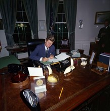 23 October 1962
President John F. Kennedy signing the Cuba quarantine proclamation in the Oval Office.

Please credit "Robert Knudsen. White House Photographs. John F. Kennedy Presidential Library and...