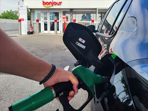 PARIS, FRANCE - JUNE 2022: Refueling a car with E10 super at a french gas station