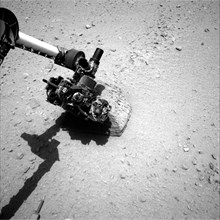 This image shows the robotic arm of NASA's Mars rover Curiosity with the first rock touched by an