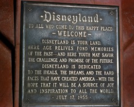 A dedication plaque commemorates the grand opening of the world’s most famous theme park, Disneyland, on July 17, 1955, in Anaheim, California, USA.  The metal tablet features a welcome “to this happy...
