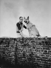 Prince George, Duke of Kent, 1902-1942  sitting on wall with dog circa 1935