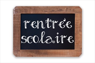 Rentree scolaire (meaning Back to school) written on a vintage blackboard with wooden frame isolated on white background