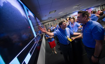 Christopher J. Scolese, Director of NASA's Goddard Space Flight Center, left, congratulates, MSL Entry, Descent and Landing Engineer Adam Steltzner as they look at the first images of Mars to come fro...