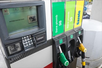 Putting,petrol,diesel,gasoline,self,service,into,Peugeot,car,at,petrol,gas,station,garage,in,Limoux,Aude,department,South,of, France,Europe,European,
