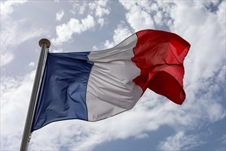 Tricolour flag against sky on the National Day of France in Nice, France