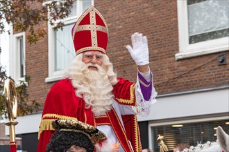 THE HAGUE, 16 November 2019 - Sinterklaas (in Dutch) riding his horse parading in the city announcing his arrival in the city escorted by his black se