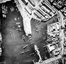 Aerial view of the port of Casablanca, Morocco, at the time of the Allied landings in North Africa. Note the sunken ship in the center of the harbour and the French battleship Jean Bart on the left. N...