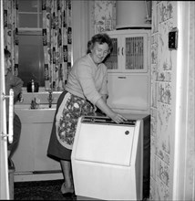 A visually impaired 1950s woman does not let her blindness affect her life as she uses the hoovermatic washing machine that has controls in braille