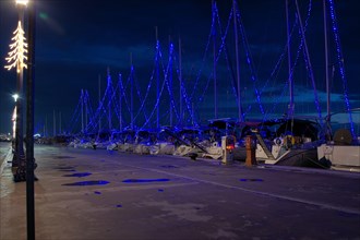 Volos city, Greece, the city of Volos decorated for the Christmas holidays,Commercial Port of Volos, ships and sailboats in the port
