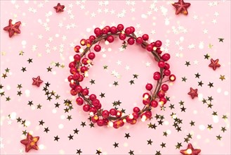 Christmas background. Red Christmas decoration on pink background. Copy space.