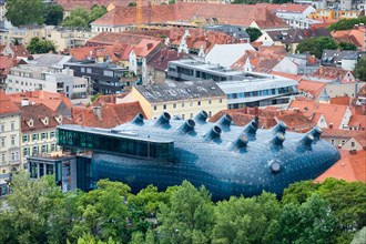 Graz, Austria - May 28 2019: Aerial view of the Kunsthaus Graz, a riverside modern art museum in amorphous blue building, with cutting-edge, temporary