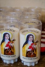 Candles dedicated to Sainte-Therese of Lisieux - close-up view, Saint-Vaast la Hougue church, Saint-Vaast la Hougue, Manche department, Cotentin, Normandy Region, France