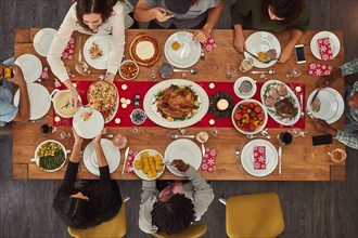 Food makes coming together easy. Shot of a group of people sitting together at a dining table ready to eat.